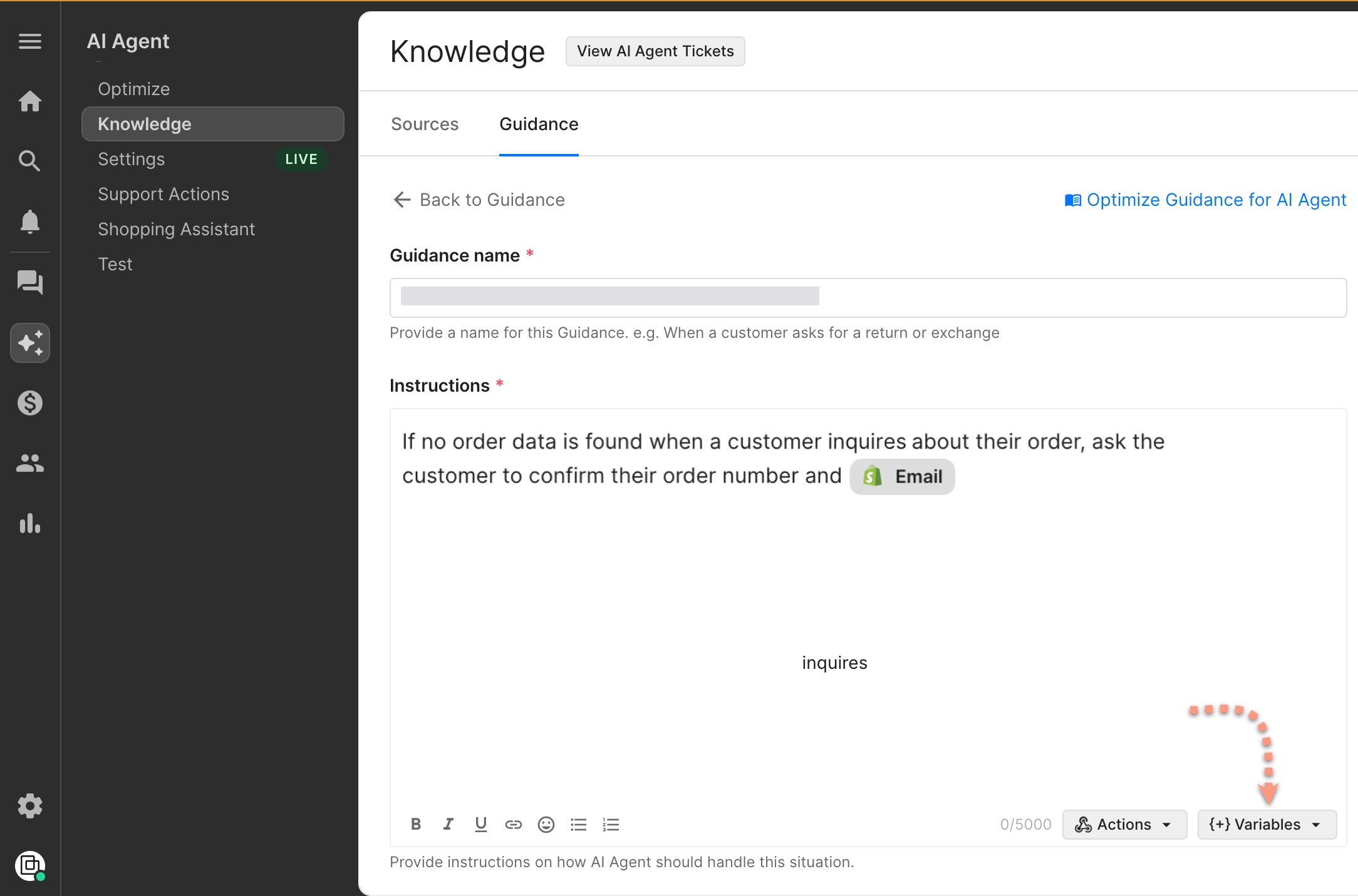The “Guidance” tab in the Gorgias AI Agent interface, focusing on the instruction entry field. The same instruction text is shown: asking the customer to confirm their order number and email. This image includes a red dotted arrow pointing to the “+ Variables” dropdown in the bottom-right corner of the instruction box.