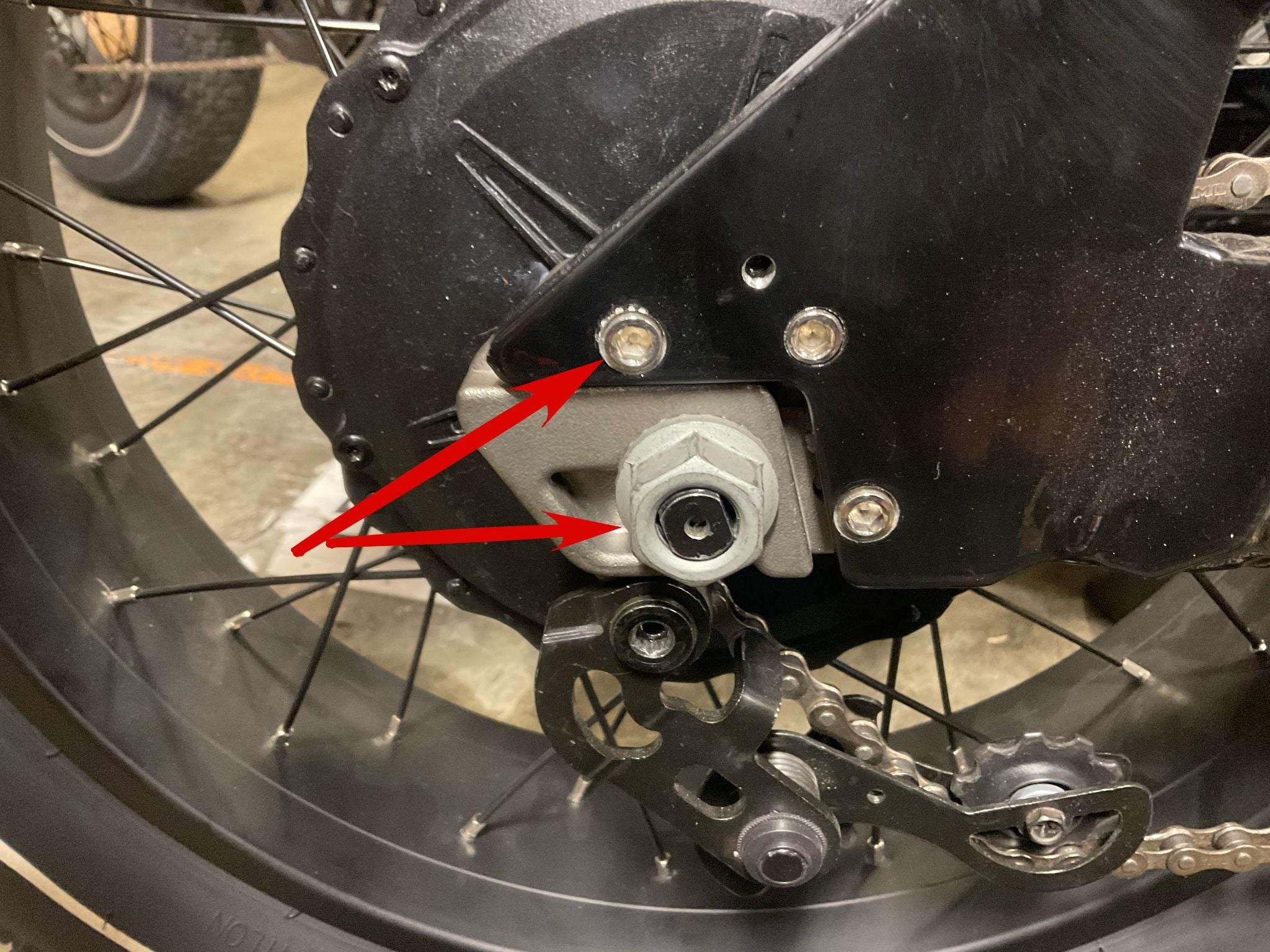 Removing axle nut and upper rear M6 bolt