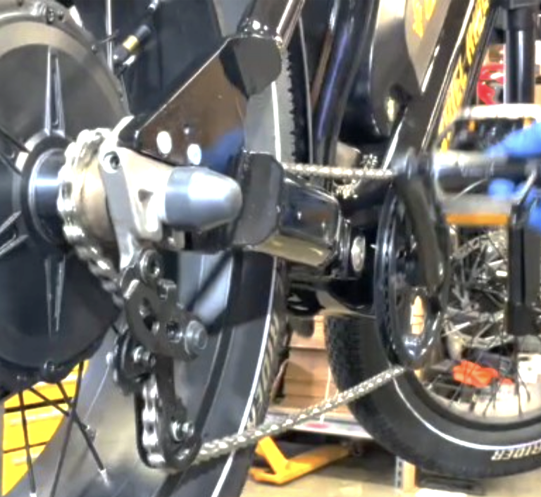 Checking the chain tensioner by back-pedaling
