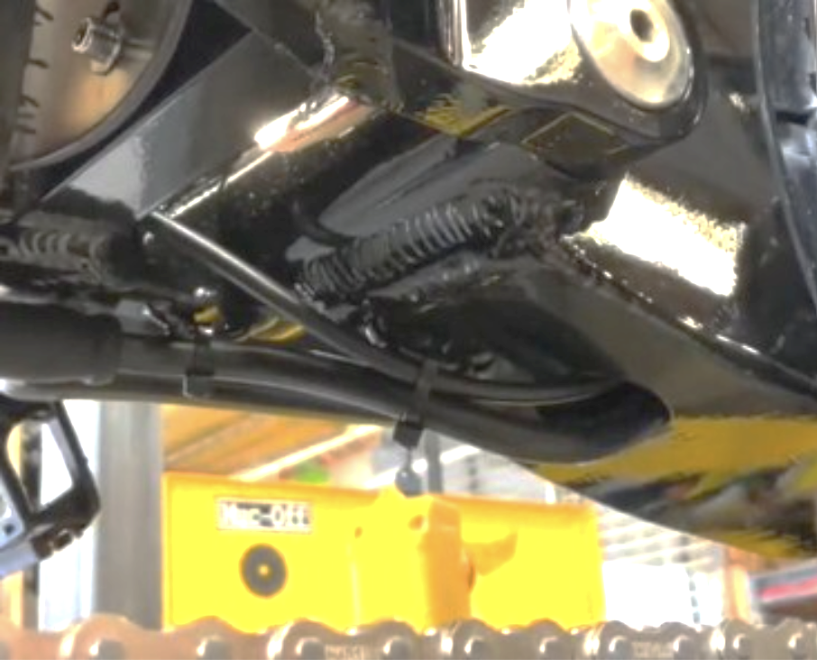 Checking cables and hoses near the swing arm for pinching
