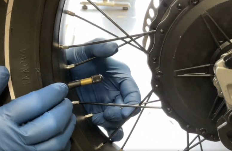 Checking spoke tension by squeezing parallel spoke pairs