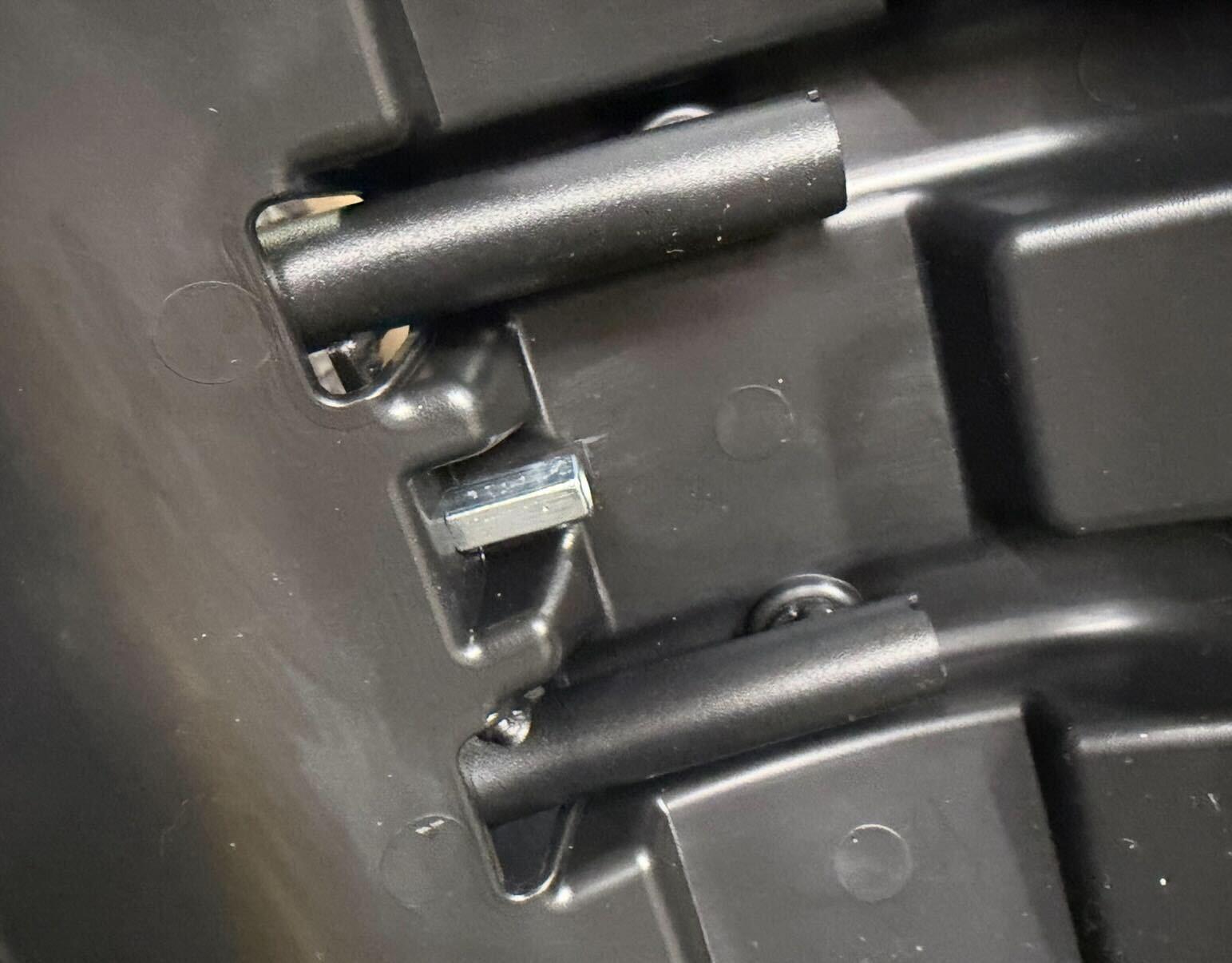 Screw installed through fender arm bridge
