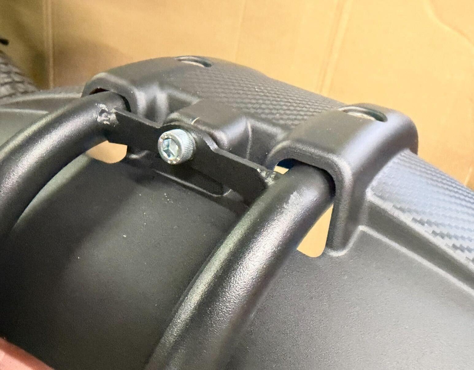 Screw and nut resting on fender arm