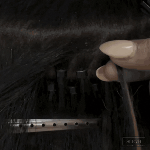 Professional hair stylist installing Kinky Straight Microlinks by SL Raw Virgin Hair 