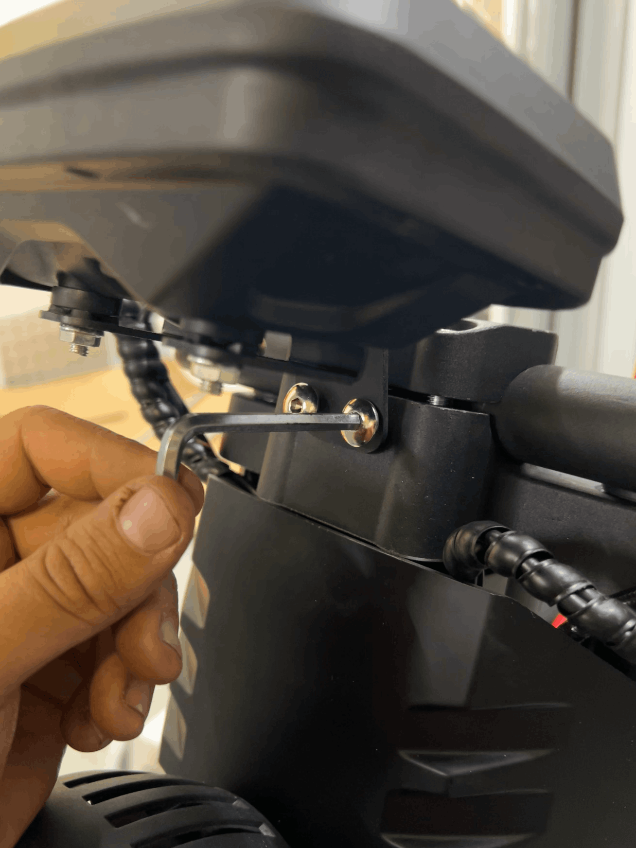 Close-up of a person tightening a screws of the display
