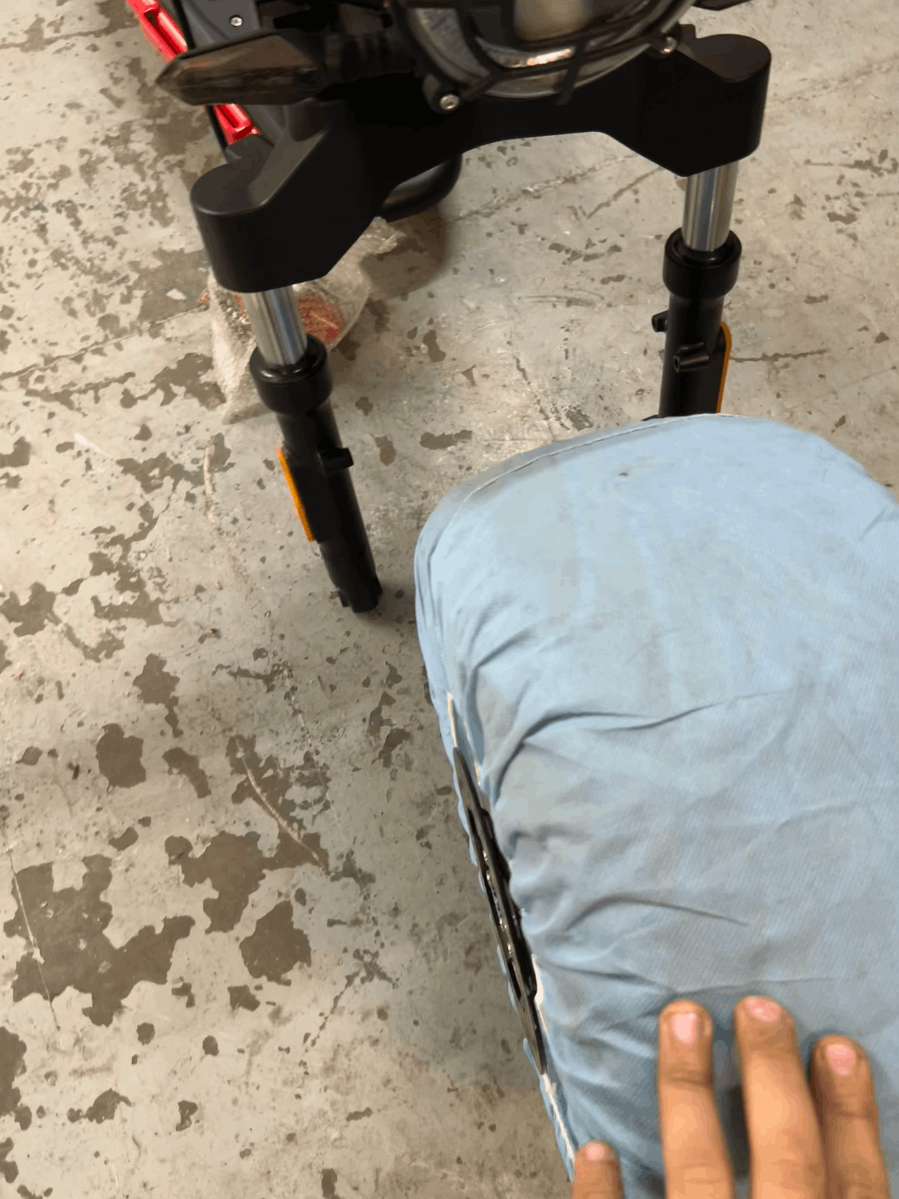 Wheel with a blue cover on a concrete floor.