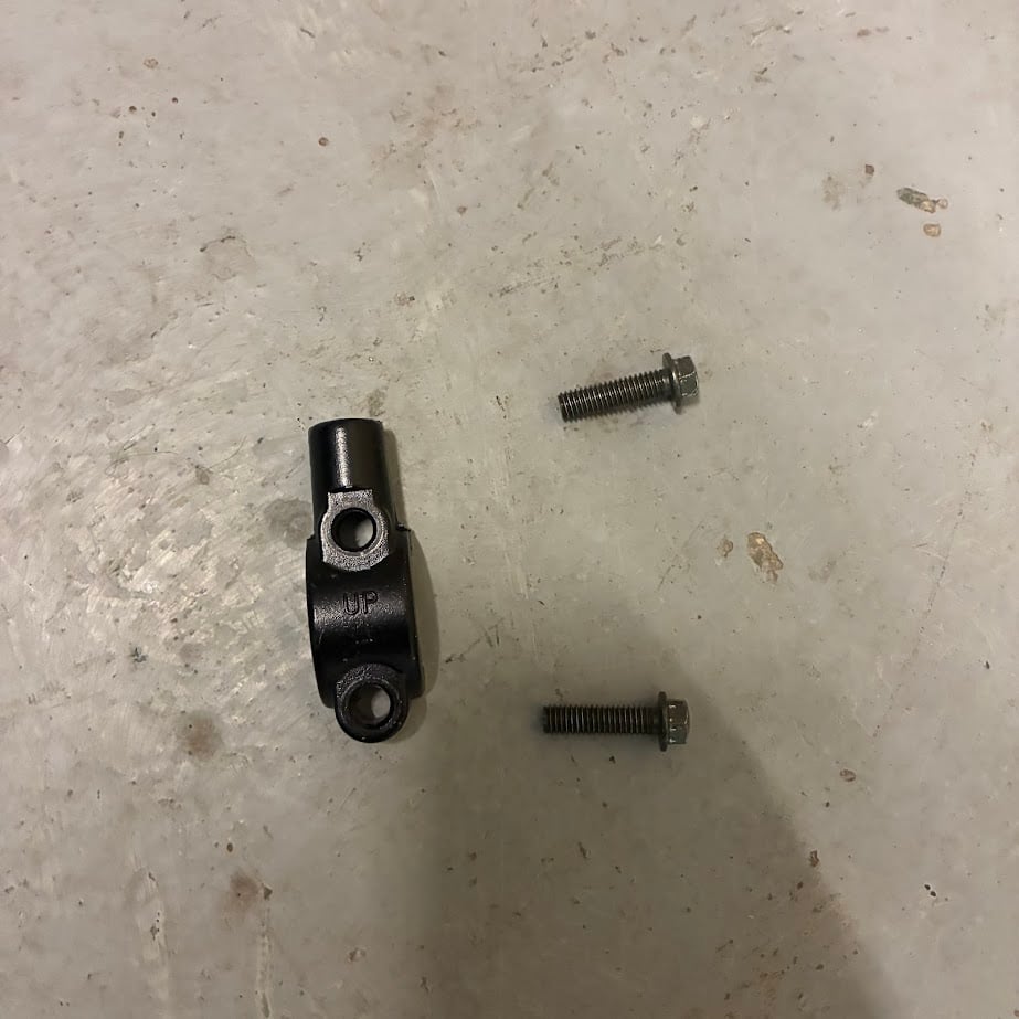 Two metal bolts on a textured gray surface