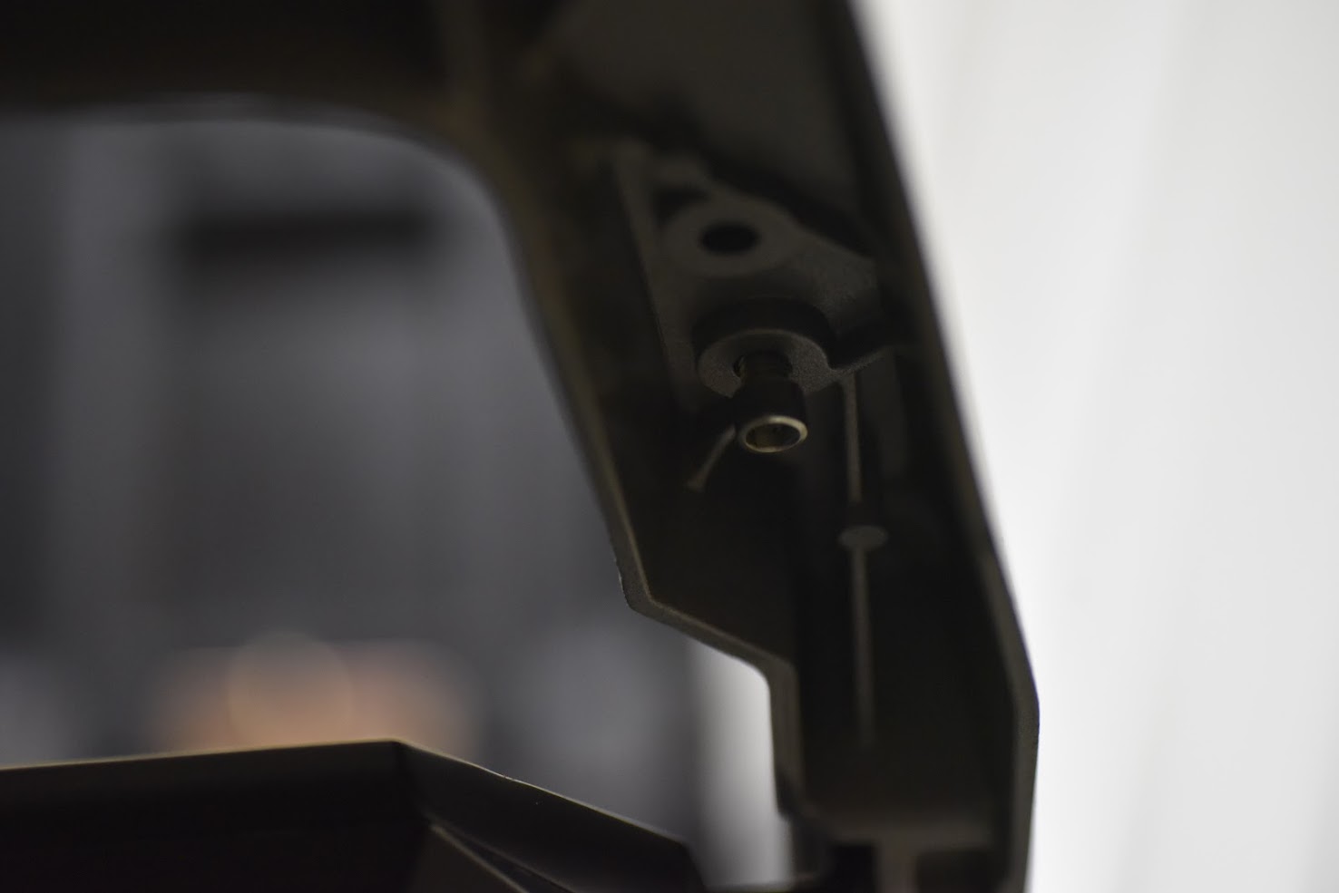 Close-up of a black metal bracket on a blurred background