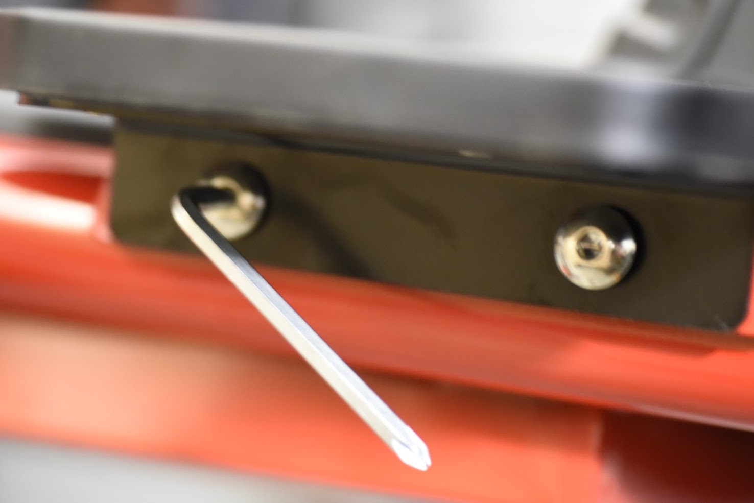 Close-up of a tool on a red surface with a blurred background