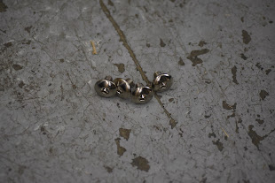 Metallic screws on a textured surface