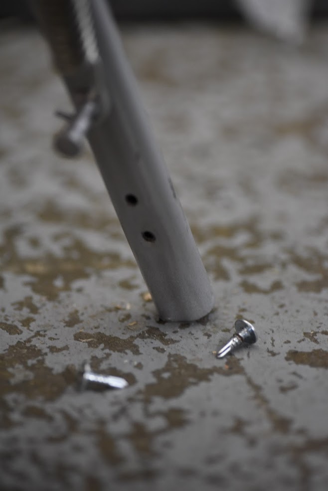 Kickstand with screws on a textured surface