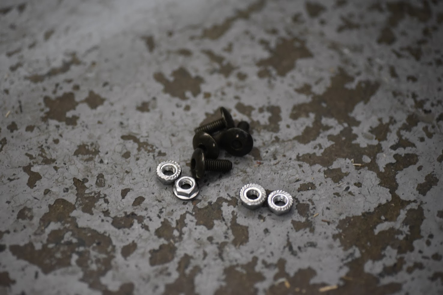 Set of screws and washers on a textured surface